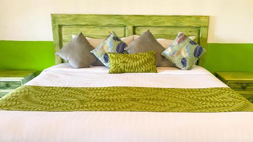 a bed with white sheets and pillows on it at Hotel Pedregal in Xico