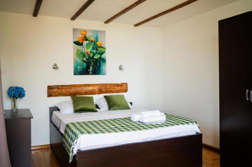 a bedroom with a bed and a painting on the wall at Livada in Gonio