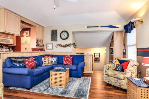a living room with a blue couch and two chairs at Gone Fishin in Nags Head
