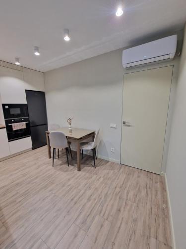 a dining room with a table and two chairs at Apartament on StyleUp in Luts'k