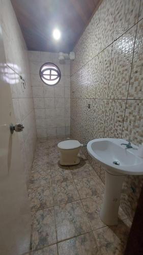 a bathroom with a sink and a toilet at casa do fred enseada in Guarujá