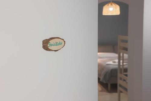 a bedroom with a bed and a sign on the wall at Casale Trifoglio in Morano Calabro