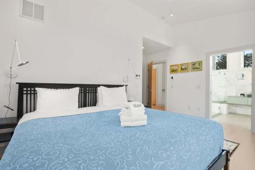 a bedroom with a large bed with a blue blanket at Coastal Luxury Near Wellfleets Best Beaches in Wellfleet