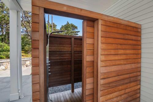 a wooden door with a window on a house at Coastal Luxury Near Wellfleets Best Beaches in Wellfleet