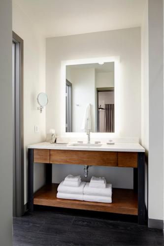 a bathroom with a sink and a mirror at Archer Hotel Florham Park in Florham Park