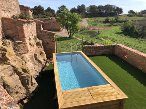 an overhead view of a swimming pool in a stone building at Can Ollé in Rubio