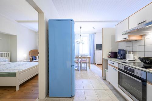 a kitchen with a blue refrigerator in a room at Landhaus Hindenburg in Bad Gleichenberg
