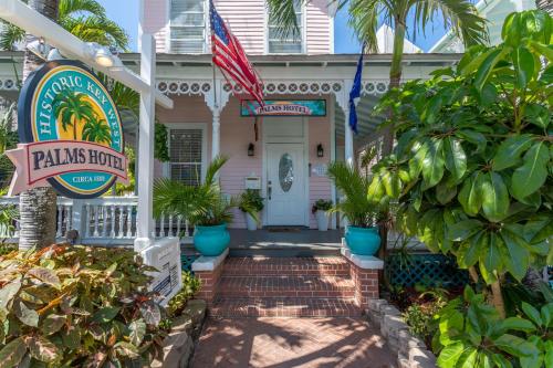 a house with a sign for the palms hotel at The Palms Hotel in Key West