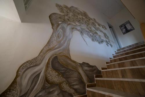 a mural of a mermaid on the wall of a staircase at Casale Trifoglio in Morano Calabro