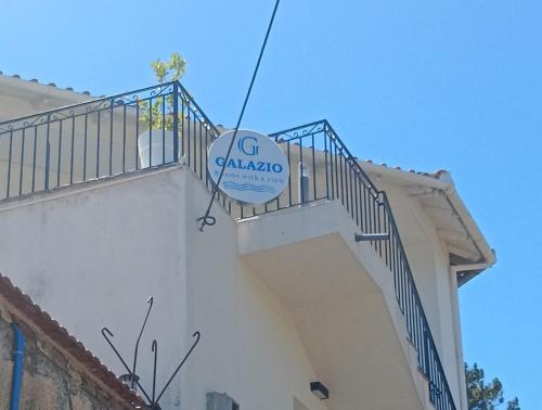a sign on the side of a building at galazio in Khorió Akhíllion