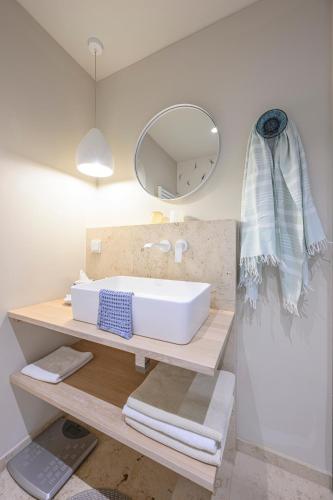 a bathroom with a sink and a mirror and towels at Landhaus Hindenburg in Bad Gleichenberg