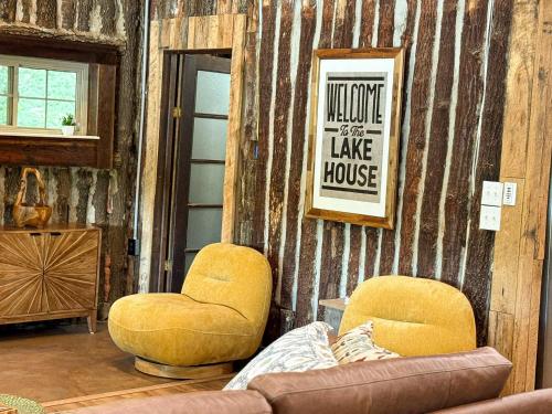 a living room with two chairs and a couch at Historic Lakefront Log Cabin4bd3badockfirepit in Camdenton