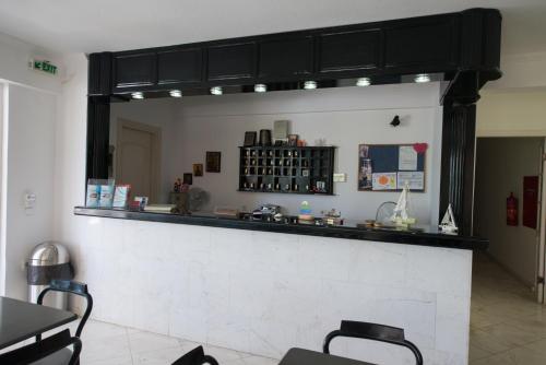 a bar in a restaurant with a mirror on the wall at Hotel Niras in Nydri