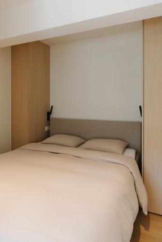 a bedroom with a large white bed in it at Studio Lou in Knokke-Heist