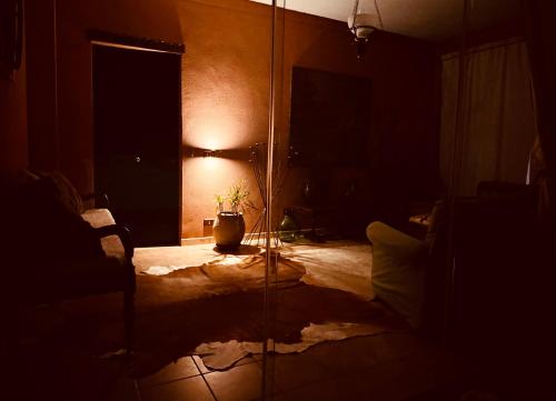 a dark room with a room with a window and a plant at Gio Country House in Nicosia