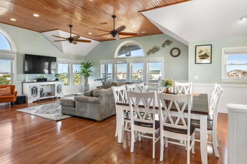 una cucina e un soggiorno con tavolo e sedie di Happy Hour a Nags Head