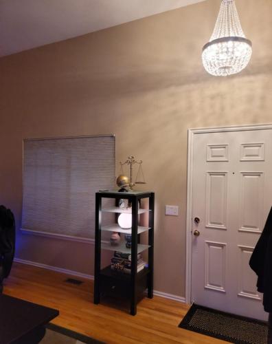 a room with a door and a shelf and a chandelier at Luxurious Highlands Ranch Home with private hot tub in Littleton