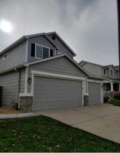 a large house with a garage at Luxurious Highlands Ranch Home with private hot tub in Littleton