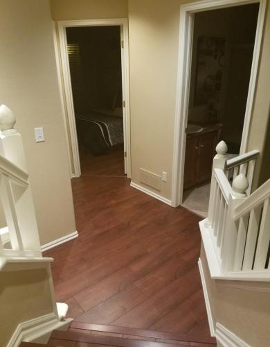 an empty hallway with stairs and a bedroom at Luxurious Highlands Ranch Home with private hot tub in Littleton