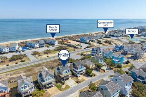 an aerial view of a neighborhood with houses and the ocean at Harrells Retreat in Nags Head