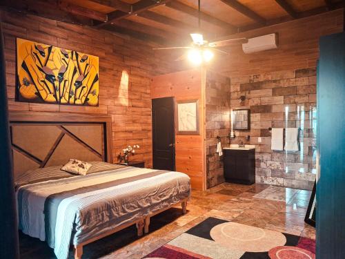 a bedroom with a bed and a sink in it at Jimmy & Yudy's place in El Triunfo