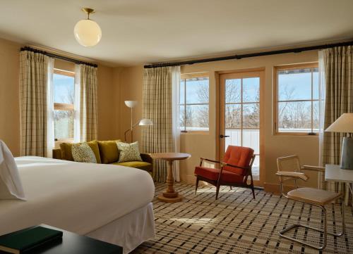a hotel room with a bed and a living room at Belden House & Mews in Litchfield