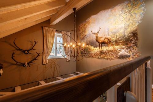 a mural of deer on the wall of a staircase at Landhaus-zum-Wilddieb in Ilsenburg