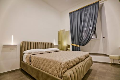 a bedroom with a large bed and a window at Dante Luxury Rooms in Naples