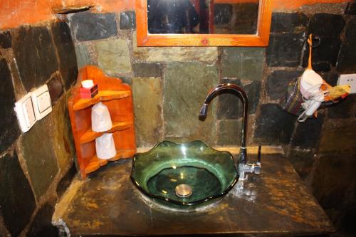 a bathroom with a green sink with a faucet at House Of Shambhala in Lhasa