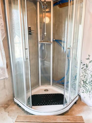 a shower with a glass enclosure in a room at Glamping Kalhagen in Vangsbygd
