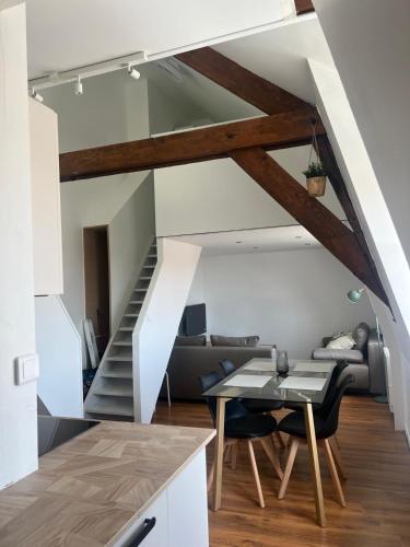 une cuisine et un salon avec un escalier et une table dans l'établissement Les Carcahutes Le Duplex, à Audresselles
