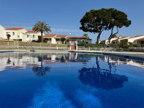 a large pool of blue water with trees and houses at Sunny Sea Garden Apartment in Mijas Costa