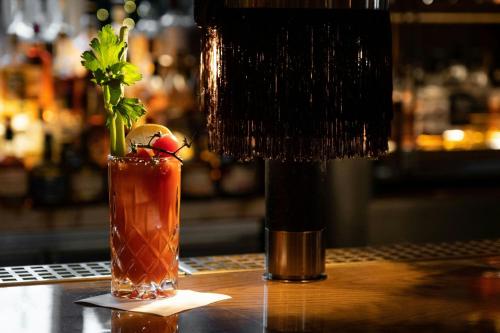 a drink sitting on a bar with a bottle at The St. Regis Toronto in Toronto