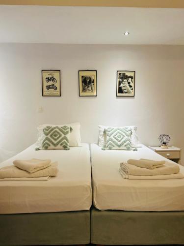 two beds sitting next to each other in a bedroom at Paradises's Nest in Agios Georgios