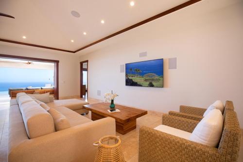 a living room with couches and a table at Hale La'i in Kailua-Kona