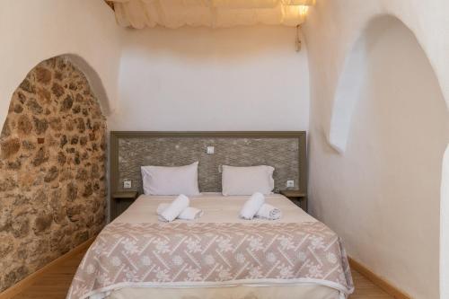 a bedroom with a bed with two towels on it at Goulas Traditional Guesthouse in Monemvasia