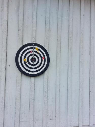 a target sign on the side of a building at Charming cottage on Kvegero in Gnesta