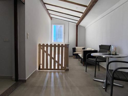 a dining room with tables and chairs and a window at Apartment Velika obala in Bibinje