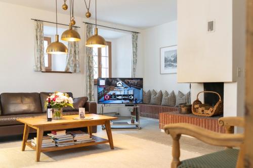a living room with a couch and a table at Chesa Michel in Bever