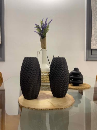 two black tires on a table with a vase at Casa Maria-Anneta in Kalyves Poligirou