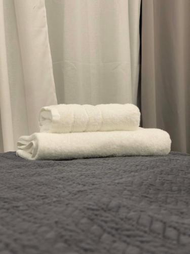 a stack of towels sitting on top of a bed at Casa Maria-Anneta in Kalyves Poligirou
