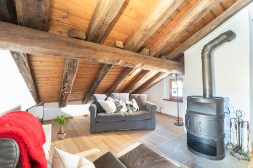 a living room with a wood stove in the ceiling at Chesa Michel in Bever