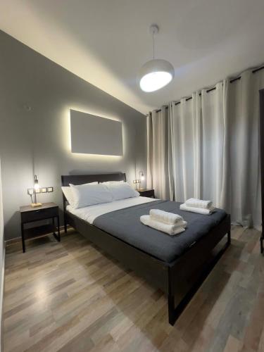 a bedroom with a bed with two towels on it at Casa Maria-Anneta in Kalyves Poligirou