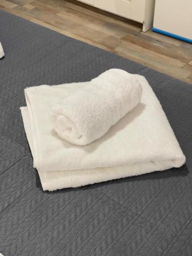 a pile of white towels sitting on the floor at Casa Maria-Anneta in Kalyves Poligirou