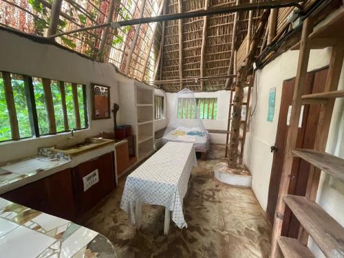 a bathroom with a table and a sink in a room at El Zopilote in Balgue