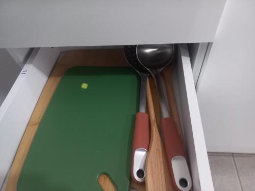 a group of wooden utensils sitting under a counter at Departamento primer piso a 5 minutos del centro con estacionamiento in Los Andes