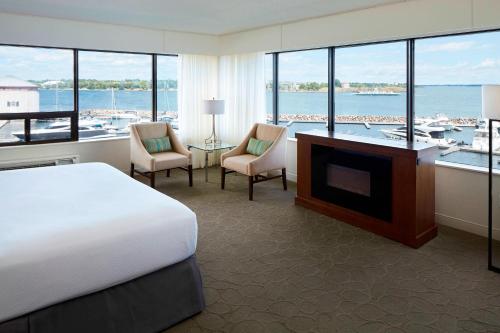 a large hotel room with a bed and a television at Delta Hotels by Marriott Kingston Waterfront in Kingston
