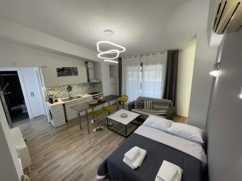 a living room with a bed and a kitchen at Casa Maria-Anneta in Kalyves Poligirou