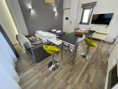 a living room with a table and a couch at Casa Maria-Anneta in Kalyves Poligirou