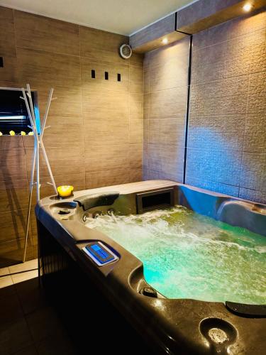 a bathroom with a jacuzzi tub with water at Willa Klif &Spa in Jastrzębia Góra